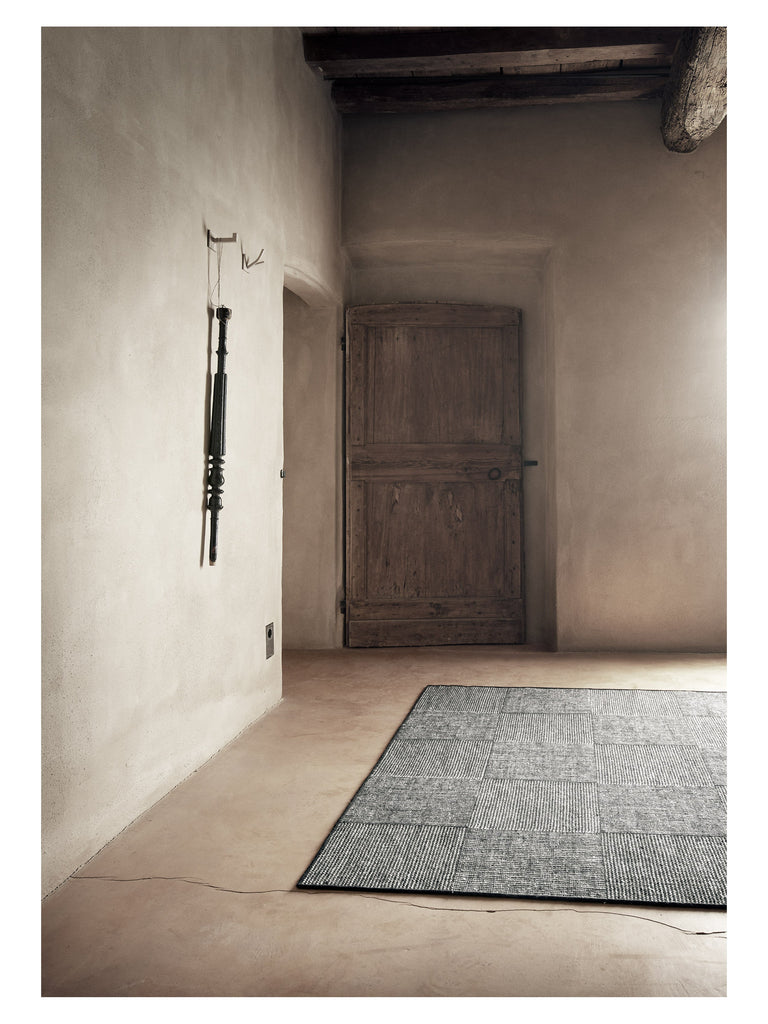 Chess Black hand-woven rug – styled in a living room | Linie Design at Bois Blanc Home, Limassol, Cyprus