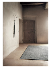 Load image into Gallery viewer, Chess Black hand-woven rug – styled in a living room | Linie Design at Bois Blanc Home, Limassol, Cyprus